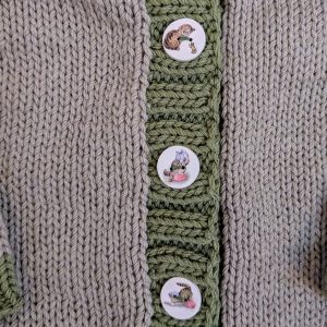 Beige Infant Cardigan with Green Trim and Kitten Buttons
